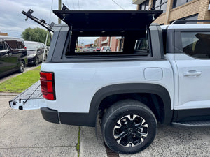 BYD Shark 6 stainless steel canopy — rear three-quarter view parked outdoors