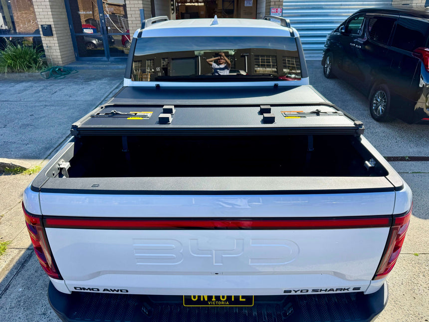 BYD Shark 6 hard lid tri-fold cover for 2025+ models installed on ute for style and security.