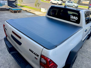 Hilux soft roll-up tonneau — rear view showing secure clip-on fit
