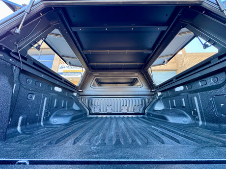 Stainless steel canopy on BYD Shark 6 — driver side view showing full canopy length