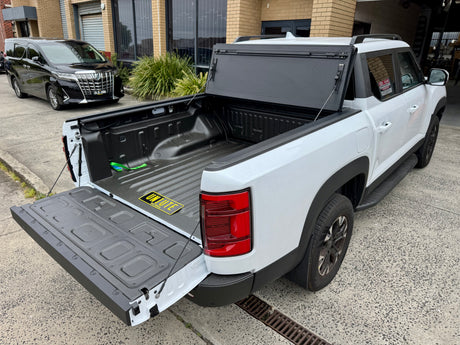 BYD Shark 6 tub cover showing quad-fold hard lid tonneau cover on 2025 model truck bed for enhanced protection and style.