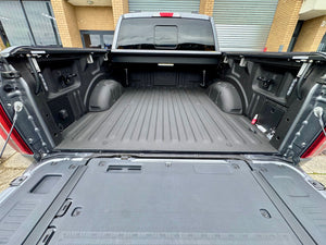 Electric roller shutter for Ford F-150 5'5" bed — half-open position showing motorised operation
