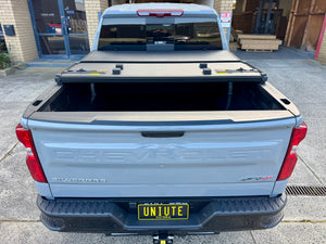 Tri-fold hard lid on Chevrolet Silverado — rubber seal and lock detail