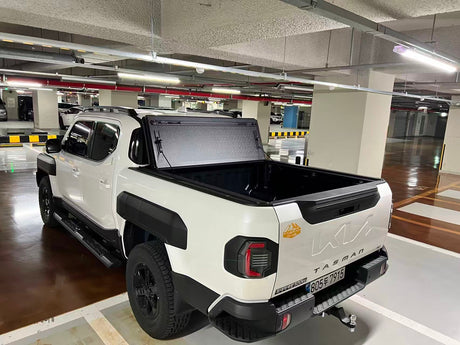 Quad-fold hard lid tonneau for KIA Tasman 2025+ — panel open showing tub access | UniUte