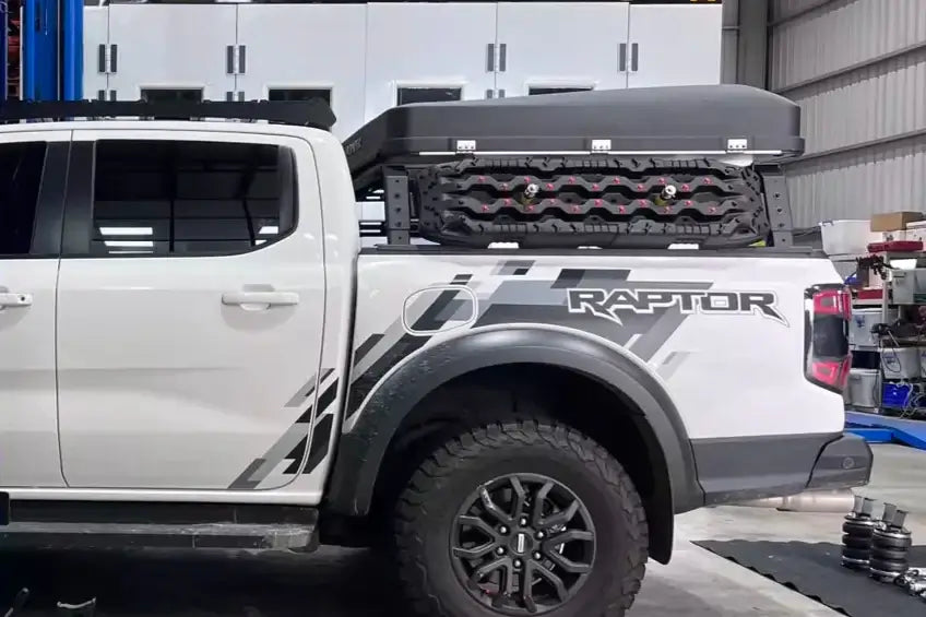 Truck with tub rack carrying gear on a rugged utility carrier cage in a garage