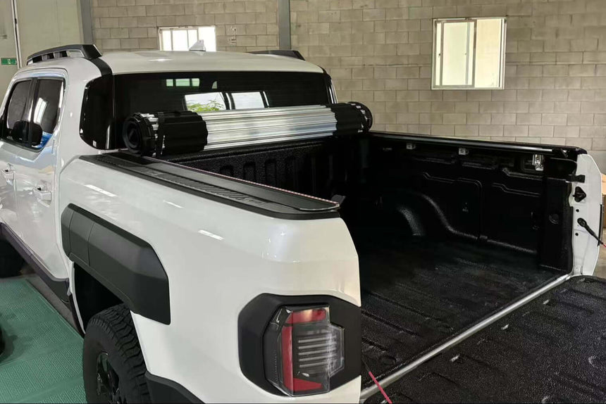 White KIA Tasman 2025+ with HR REVOLVER Hard Rolling Cover installed in open position, showcasing storage space, kia tasman hard cover