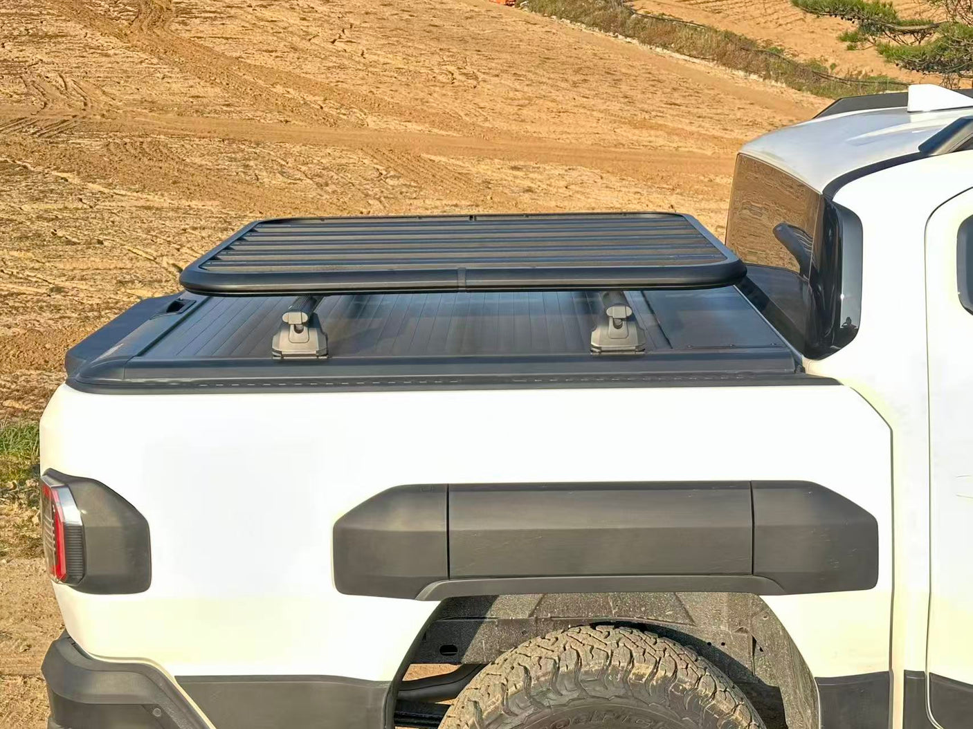 Kia Tasman Roller Shutter 2025+ Gen2 Manual by UniUte on a white ute in a rugged outdoor setting