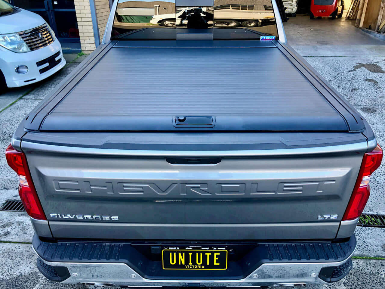 Chevrolet Silverado 1500 electric roller shutter — parked at accessories shop