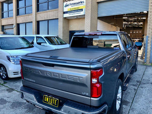 Silverado 1500 with UniUte electric roller shutter — side view showing shutter closed
