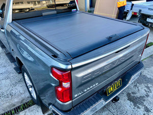 Chevrolet Silverado electric roller shutter — parked showing matte black slat design