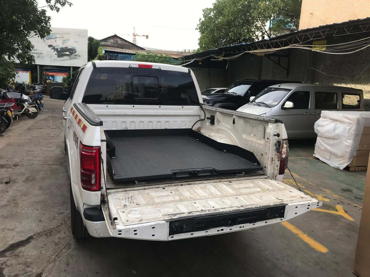 Ford F-150 with a slide out tray in the 5'5" ute bed showing extended storage convenience