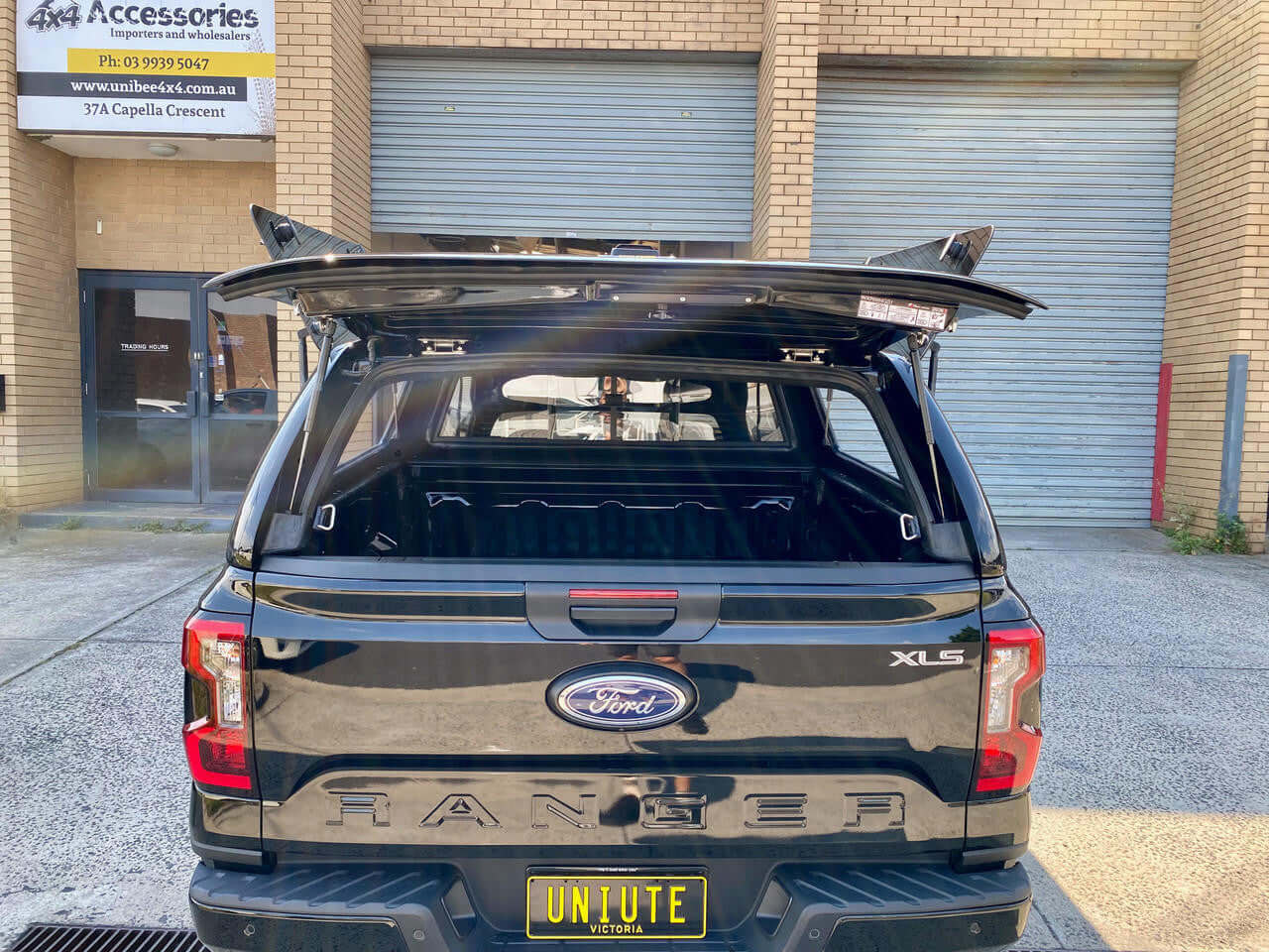 Ford Ranger canopy for RA NextGen 2022-2025, open tailgate view, highlighting security and style for work and adventure.