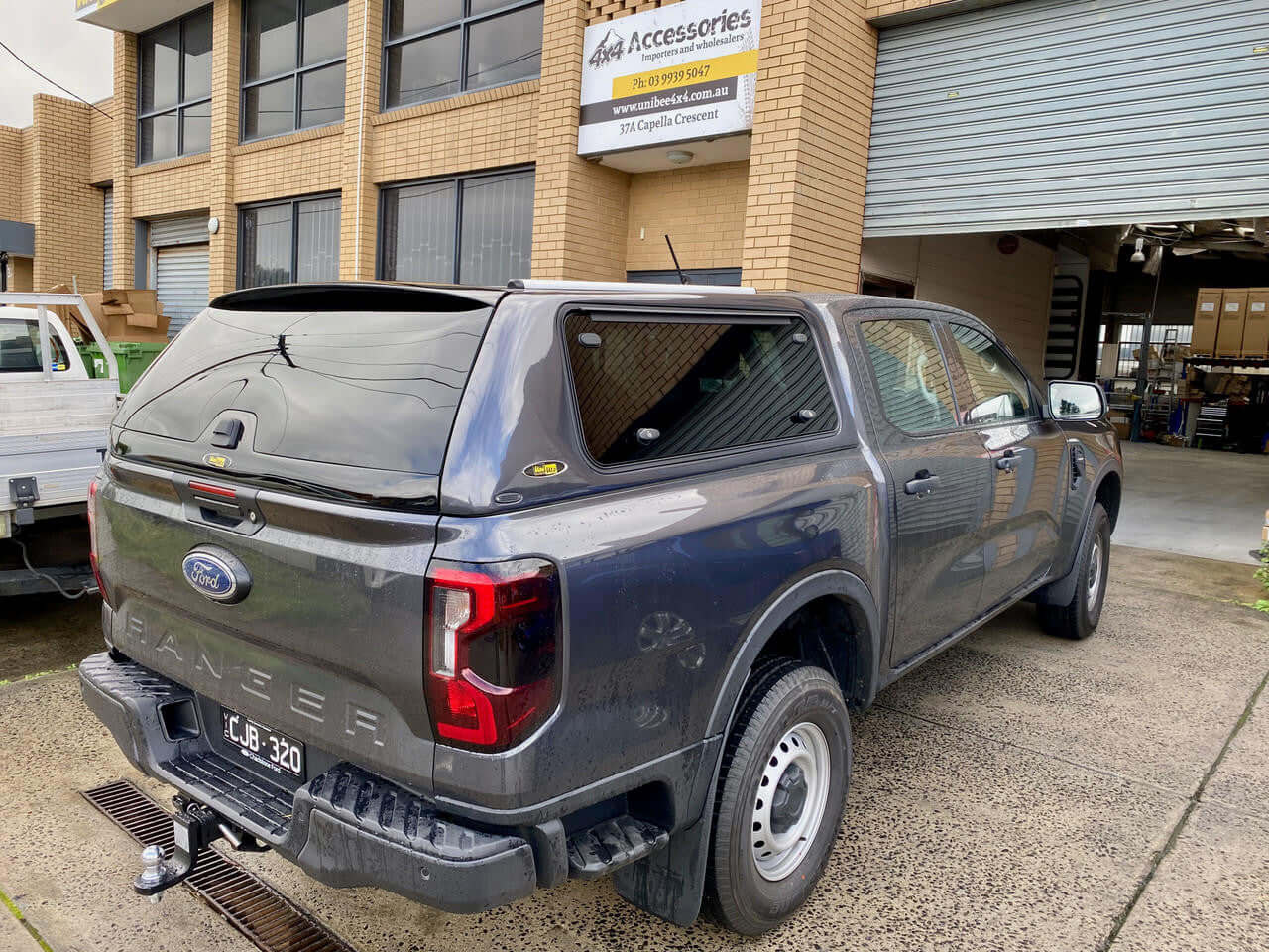 Ford Ranger canopy parked outside a building, showcasing the ford ranger canopy versatility and style.