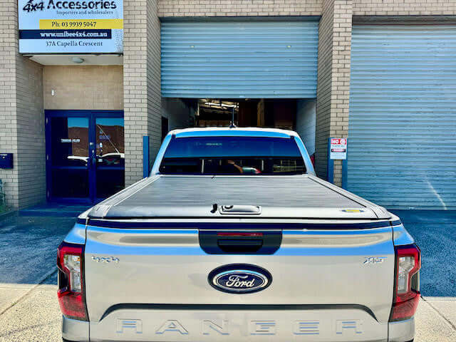 Next Gen Ford Ranger with UniUte ranger roller shutter at a 4x4 accessories shop.