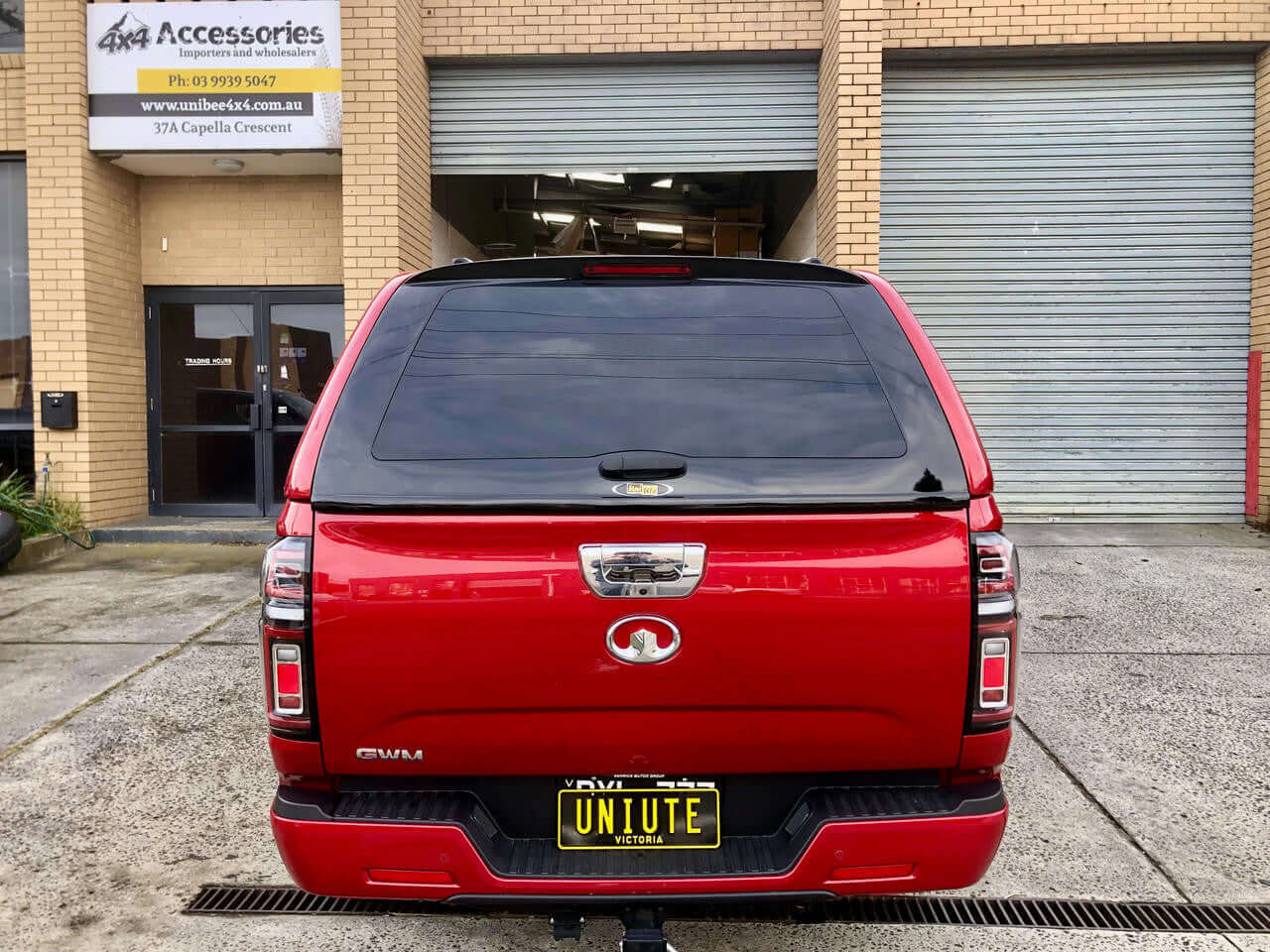 Red 2020 GWM Cannon canopy in front of accessory store