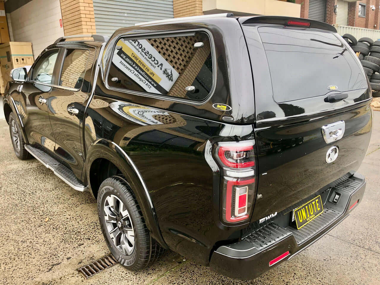 Black GWM Cannon canopy 2020-2025 model displayed on wet pavement.