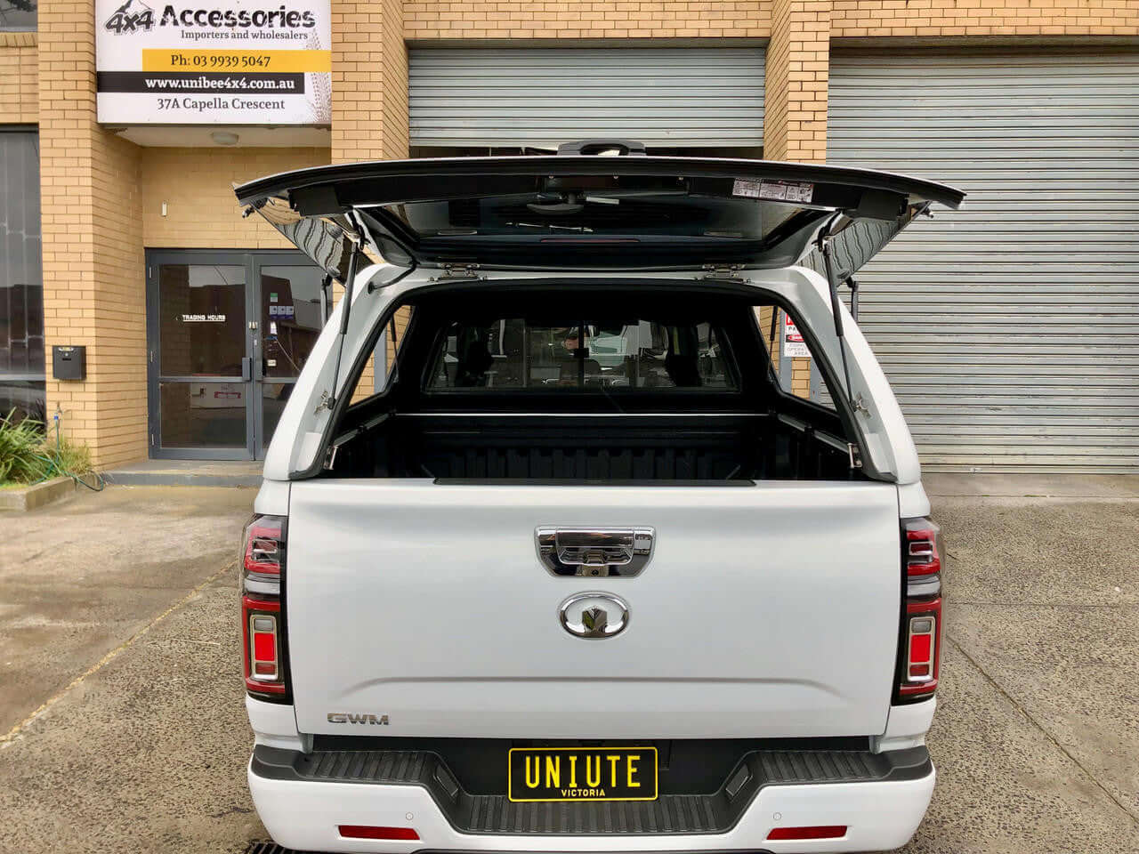 GWM Cannon Canopy 2020-2025 UniUte FORCE PRO installed on vehicle, rear view showcasing open canopy door.