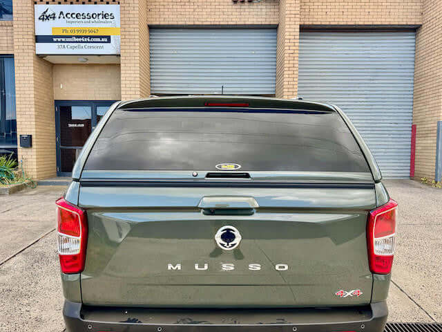 Back view of SsangYong Musso with canopy for ssangyong musso installed at 4x4 Accessories shop.