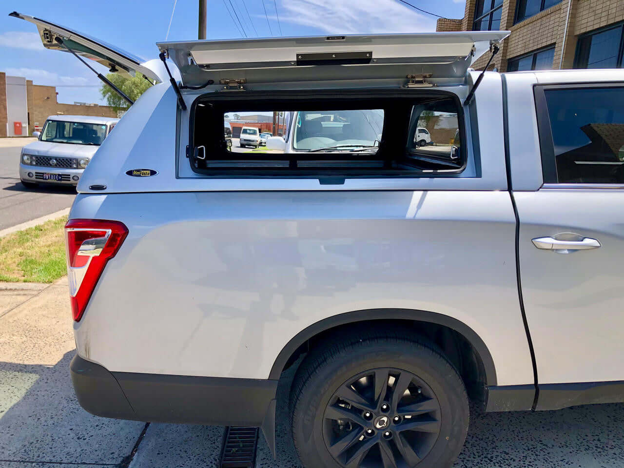 SsangYong Musso XLV Canopy installed on a pickup truck, featuring open rear window.