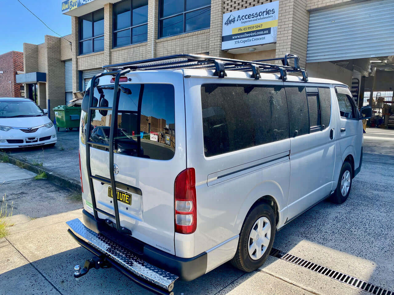 Toyota HiAce 200 series 2005-2019 rear ladder — showing roof access position