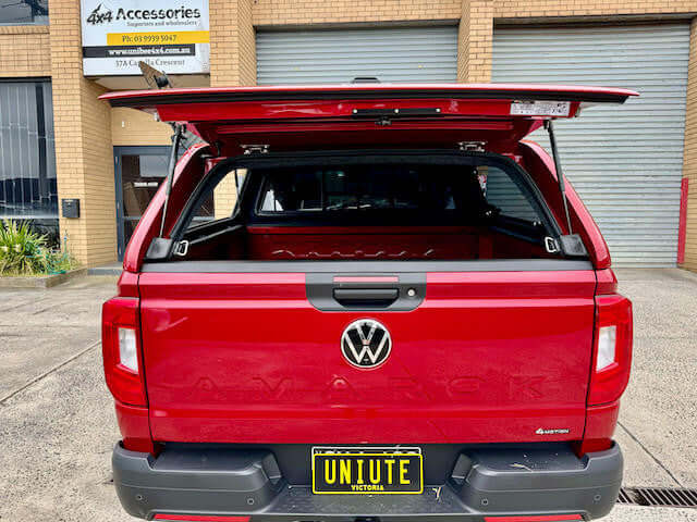 Red Amarok canopy by UniUte for Volkswagen 2023, showcasing enhanced storage solutions.