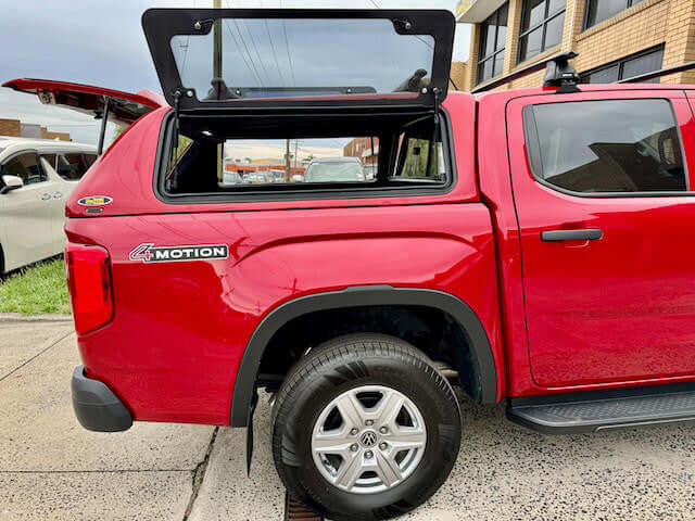 Red Volkswagen Amarok canopy opened, featured for amarok canopy installation.