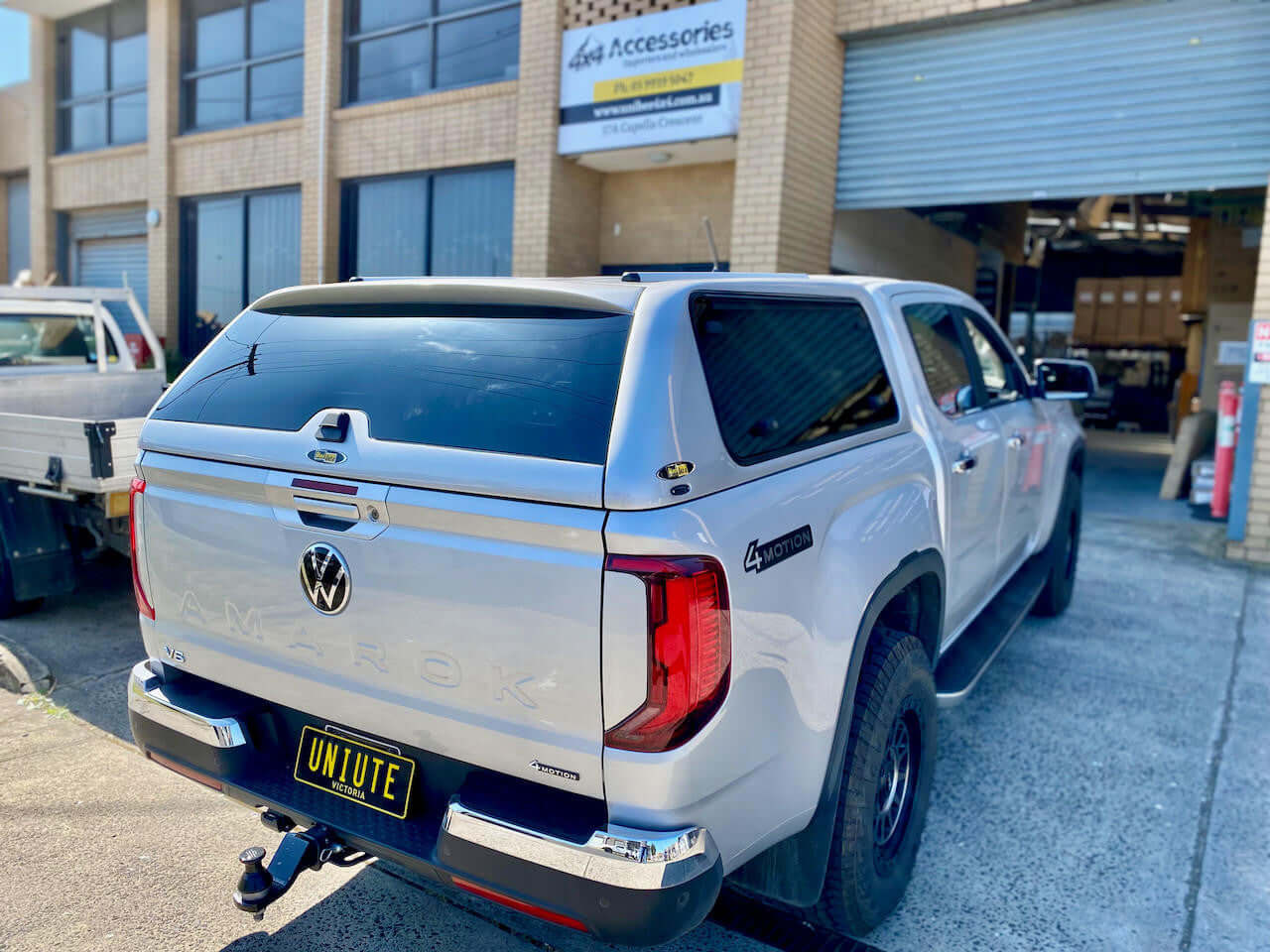 New Volkswagen Amarok Canopy by UniUte parked outside a workshop. Focus keyword: amarok canopy